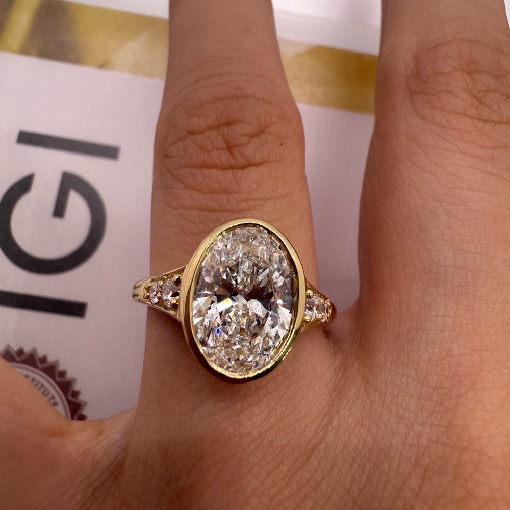 3.02 carat E VS1 oval bezel with round accent stones Diamond engagement ring